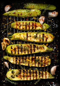 Grilled zucchini with addition of thyme, lemon zest and garlic