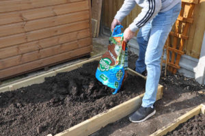 fill the garden beds with quality topsoil