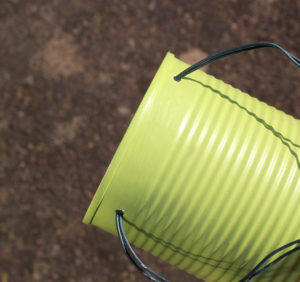 use wire to attach your tin plant pot to a fence