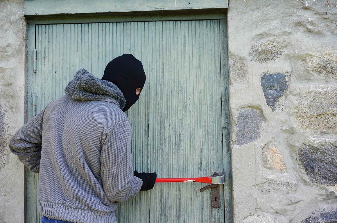burglar breaking through a door